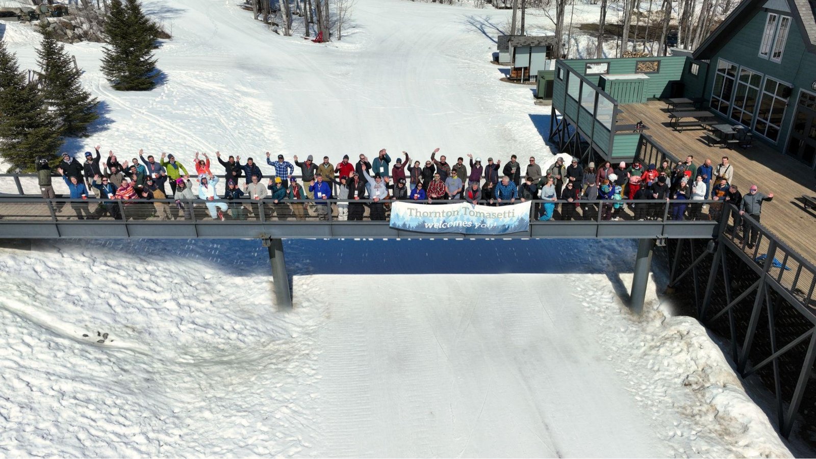 Aerial photograph of people standing on a bridge 