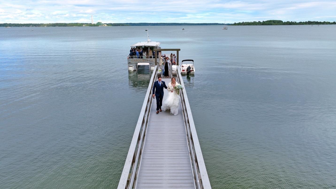 Drone view of a destination wedding set along a riverbank.