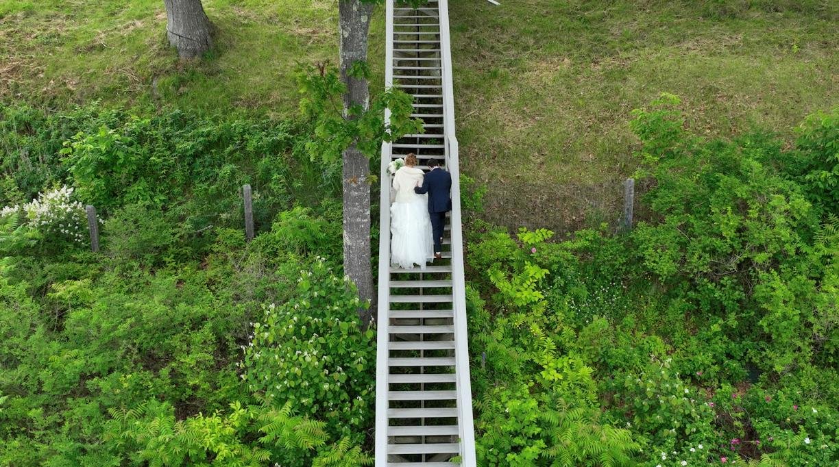 The image shows a couple going up on the stairs