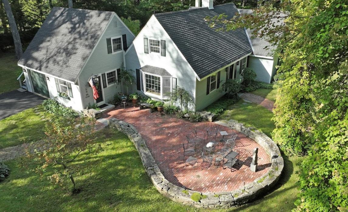 Aerial view of a house with a backyard