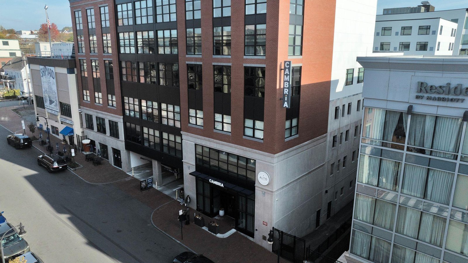 Aerial drone view of the Cambria Hotel and surrounding commercial buildings.