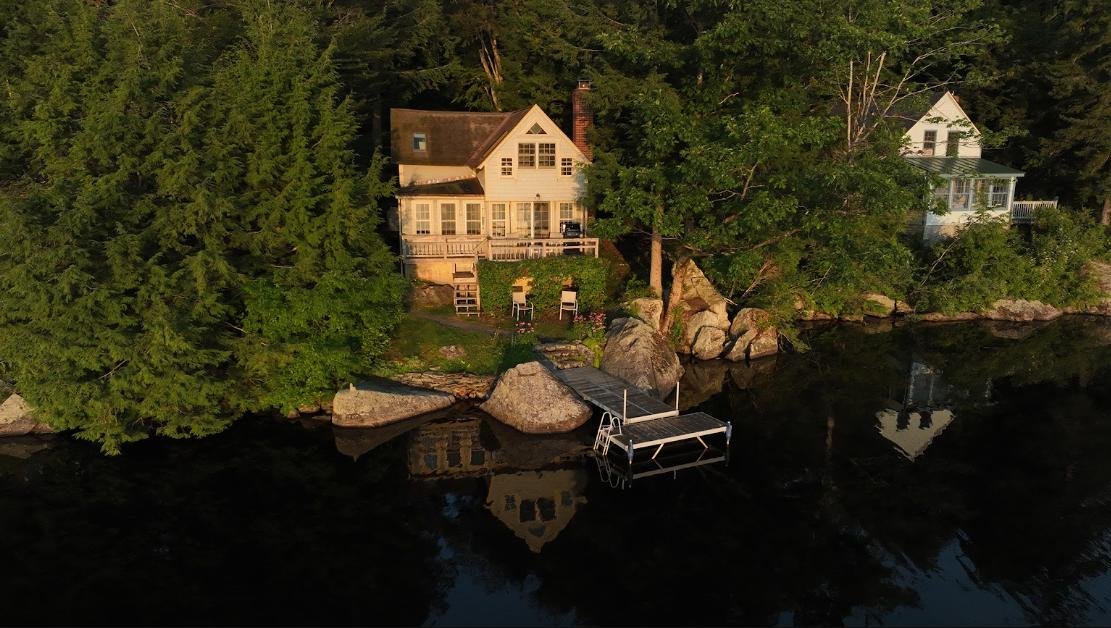 Aerial drone photograph of a residential property with a paved driveway