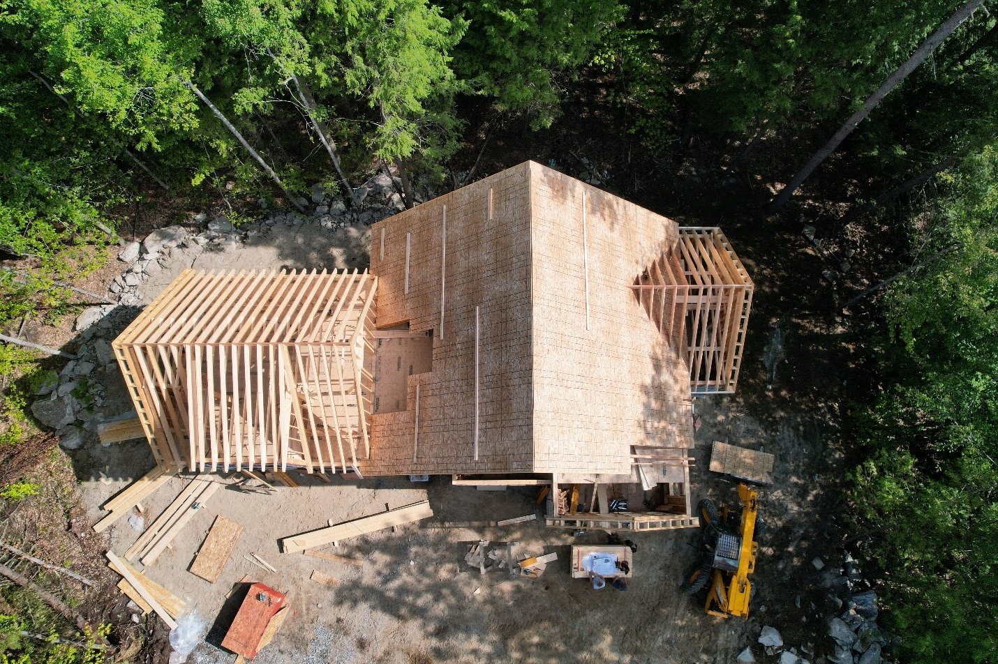Aerial drone photograph of a home under construction with visible framing