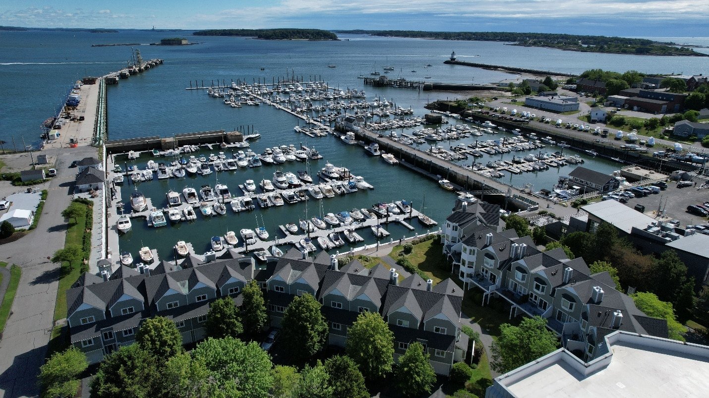 Aerial drone photograph of a Maine marina with docked boats