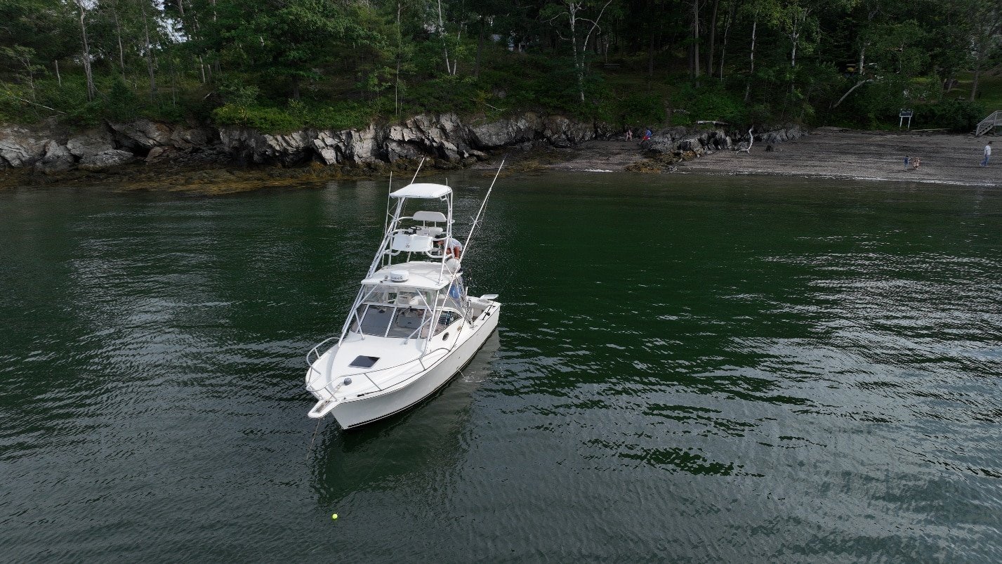 Aerial drone photograph of a boat on the water near the Maine coast